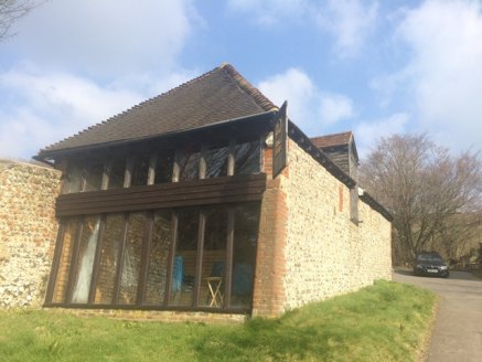 The premises comprise a detached part two-storey timber-framed barn with external single storey stores and substantial yard/car park. The Barn provides ground floor showroom, W.C and kitchenette with stairs leading to the mezzanine.