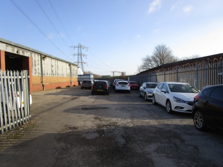 The property comprises a single warehouse/industrial unit with an attached single storey flat roof office. The warehouse is constructed with a steel portal frame with masonry walls to half height under a sheeted roof. The warehouse has a minimum eave...