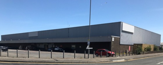 The property comprises a large detached warehouse/ industrial unit standing on a self-contained site. 

The building is of steel portal frame construction incorporating brick / blockwork and profiled steel cladding beneath a pitched lined roof incorp...