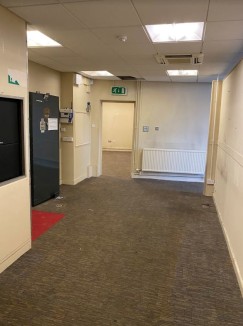 The accommodation has curved frontage around the junction of Wigan Road and Gerard Street and comprises ground and first floor. The ground floor forms a former banking hall/retail area, offices and a strong room while the first floor provides ancilla...