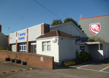 A detached single storey building of part brick, part rendered block elevations under a pitched clad roof. There is an extension with rendered block elevations under a pitched tiled roof....