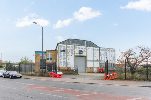 The property comprises a self-contained purpose-built warehouse of masonry construction. The warehouse is accessible via two full length roller shutters at both the Nathan Way and Kellner Road ends of the unit. Access to the reception and office area...