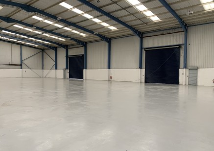 A modern portal frame warehouse/workshop unit incorporating two storey offices and having a yard to the rear which is surfaced in concrete hardstanding.

A separate car parking area surfaced in tarmacadam, is provided to the front of the property.

V...