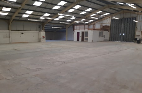 Open plan light industrial/workshop/warehouse unit with 12' (3.66m) eaves rising to 18'6 (5.48m). 5m wide x 4.75m high concertina loading door to front leading to large external concreted area suitable for loading and vehicle parking....