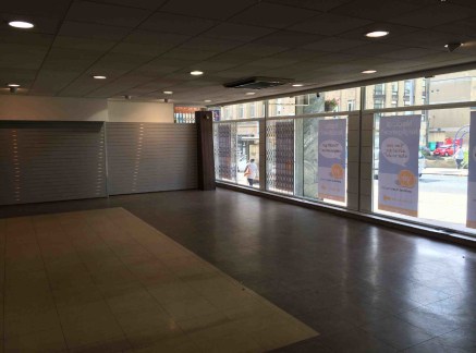 The property comprises the ground floor of a larger multi storey office building and provides predominantly open plan retail showroom accommodation benefiting from a substantial glazed frontage including internal security shutters to High Street.

Th...