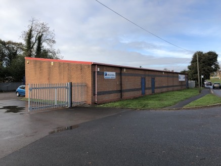 An end terraced single storey industrial unit standing within a secure yard with shared parking available.