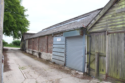 The property comprises a storage building with large loading door (not wide enough for vehicles), solid floor, strip lights and an eaves height of 2.25m rising clear.

2 parking spaces are available - more storage space may be available if required.