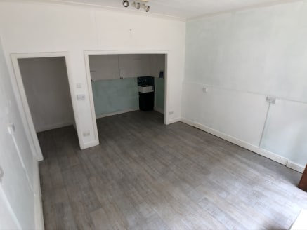 The property comprises a self contained ground floor retail unit benefiting from a prominent shop frontage with sliding steel security grills together. Internally the property provides open plan retail accommodation with timber effect flooring, paint...