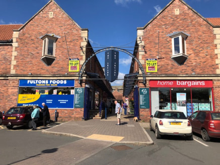 The unit is located opposite Home Bargains within The Arcade and is arranged over ground floor level comprising an open plan sales area with rear w/c.