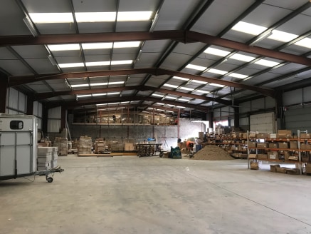 The premises provide industrial/warehouse premises constructed in 1991 with a steel portal frame construction and brick facing elevation with profile steel elevations above.\n\nThe premises benefit from an eaves height of 6.1m (20'), clear internal h...