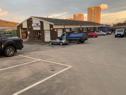 The property comprises a steel portal frame industrial unit with a pitched cement sheet roof, part brick and part clad walls and a concrete floor. Loading to the warehouse is by a ground level roller shutter door to the front elevation and a dock lev...