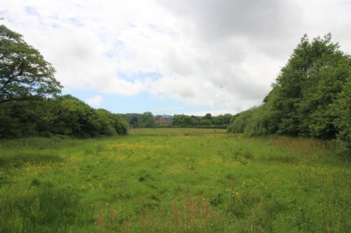 A parcel of gently sloping arable and pasture land with woodland shaws and pond. In all about 26.43 acres (10.7 ha).