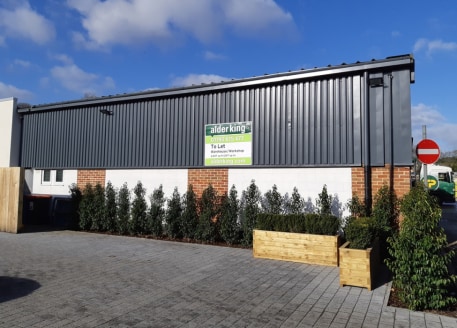 Light industrial unit of clear span concrete roof truss construction with part profile steel cladding and part brickwork elevation under steel clad roof. 4.27m (14') internal eaves height. Loading door and pedestrian door to front. Second double pede...