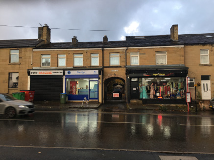 The property comprises a terrace of three tenanted lock-up shop units, producing a combined rental income of £14,560 per annum, with an attached three bedroom dwelling and one bedroom flat. The residential aspect of the property requires modernisatio...