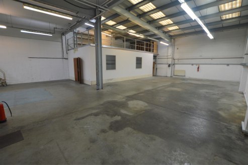 The property comprises an end of terrace industrial unit with profile clad elevations under a pitched roof. The ground floor warehouse benefits from a roller shutter door, a reception / entrance area, kitchen, toilet facilities and an office/studio s...