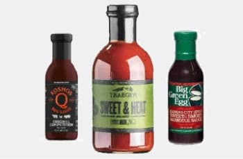 A sampling of the sauces we offer, including Kosmos Q Competition BBQ Sauce, Traeger Sweet & Heat sauce, and Big Green Egg Kansas City Sweet & Smoky sauce