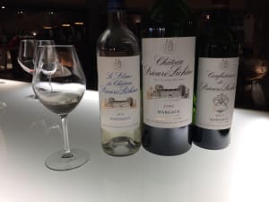glasses of red Bordeaux wine lined up for a comparative tasting at a private château visit