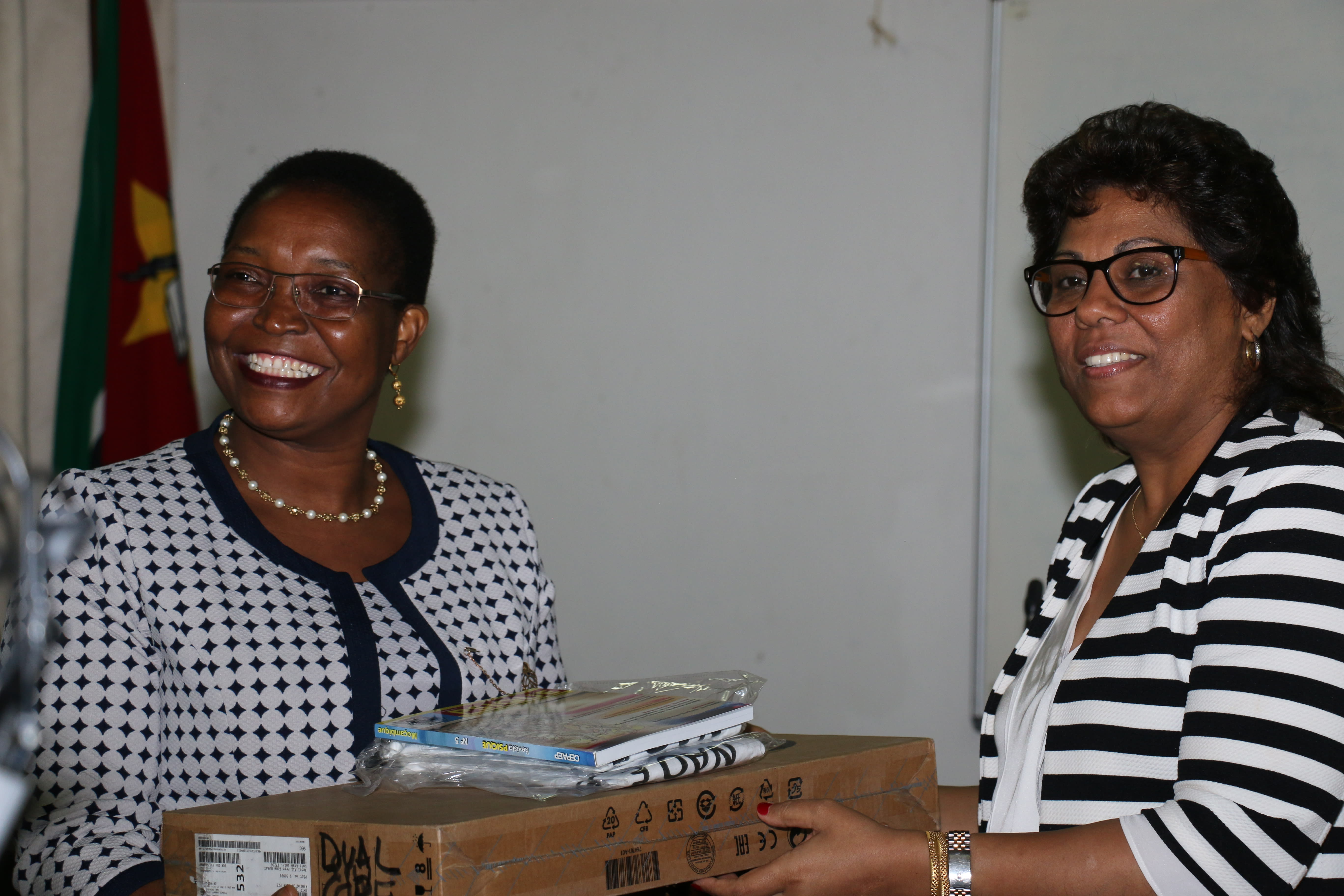 Mozambique’s Minister of Health Dr Nazira Abdula (right) gives an award for the winner of the school-based contest on epilepsy awareness. Receiving the prizes (left) is Dr Virgínia Albino, coordinator of the epilepsy program in Zambézia province.