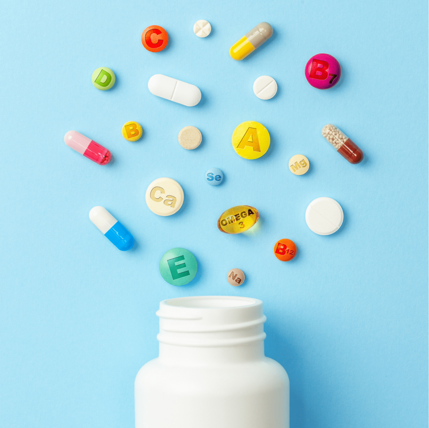 colorful pills spilling out of bottle