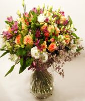 Gentle round bouquet of pink, purple and white flowers