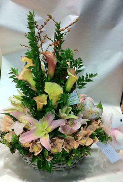 Flower arrangement in basket with season exclusive flowers