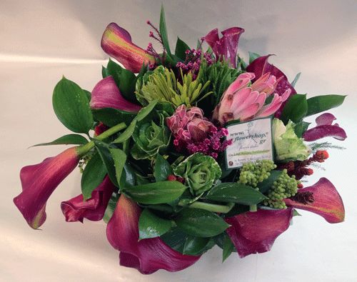 Flower arrangement in ceramic pot with african safari greens