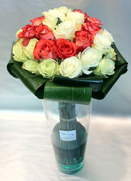 31 roses bouquet in vase with colored water