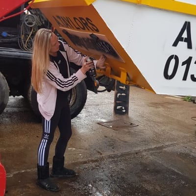 Lady Checking Taylors Skip Hire Delivery Truck