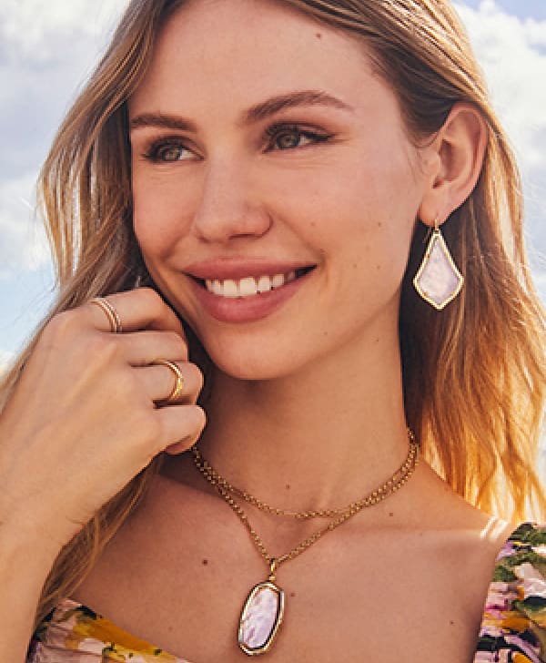 Women wearing colorbar necklace and earrings