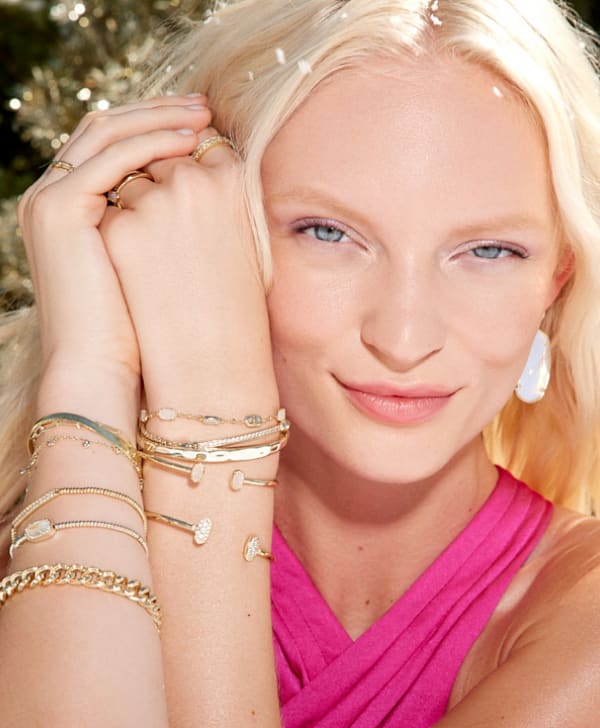 Model wearing multiple pieces of jewelry