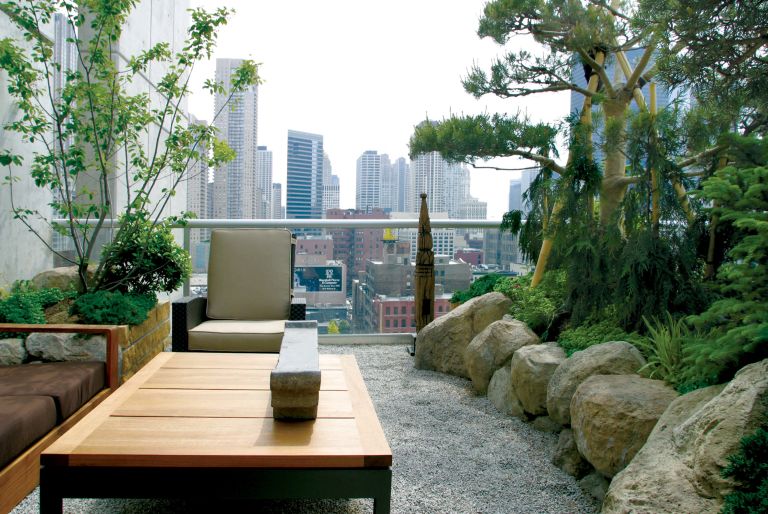 rooftop garden with chair and seating and trees, view of Chicago