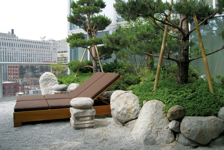 lounge chair in penthouse rooftop garden with views of Chicago