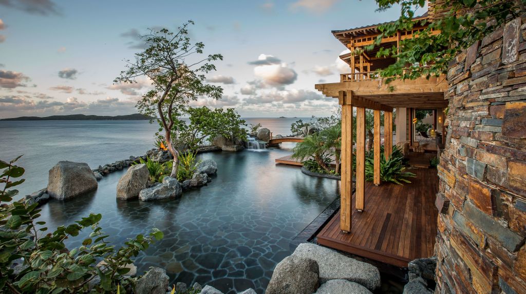 porch view of water with trees and rocks at British Virgin Island residence