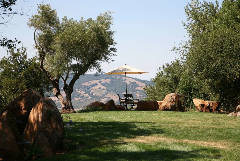 view of table and umbrella with mountain background at Brand Vineyards
