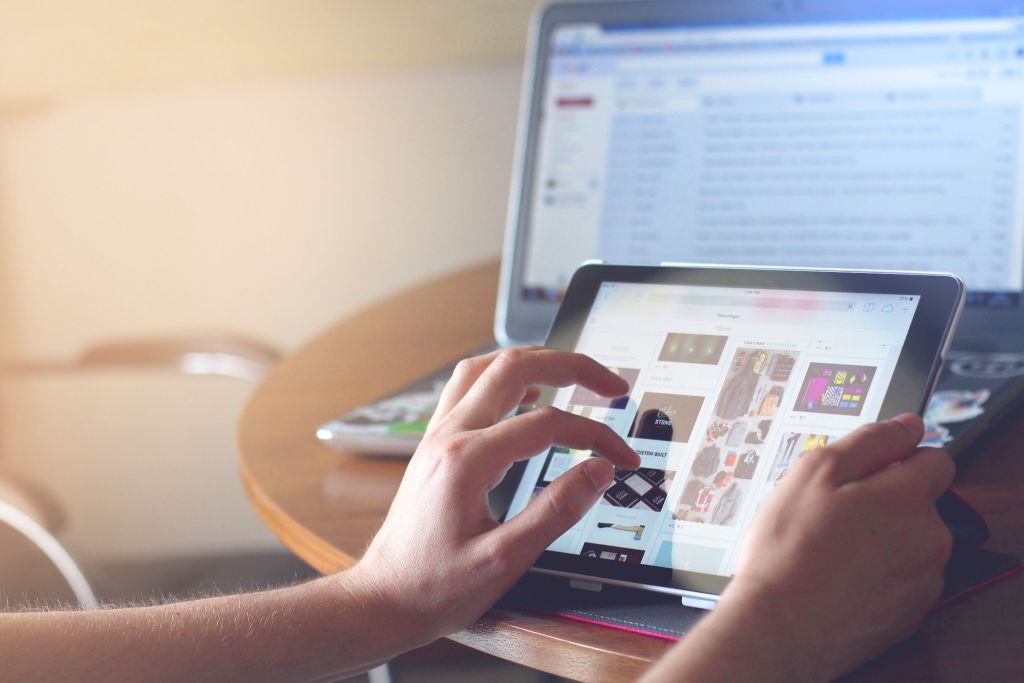 Photo of a person reading news on their tablet device