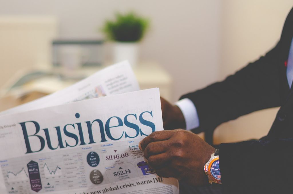 Photo of a man reading a newspaper