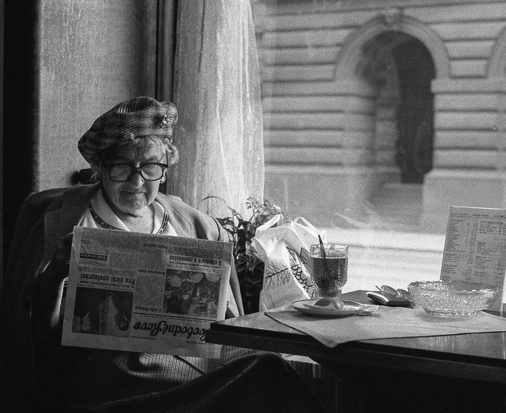 Photo of a woman reading a newspaper