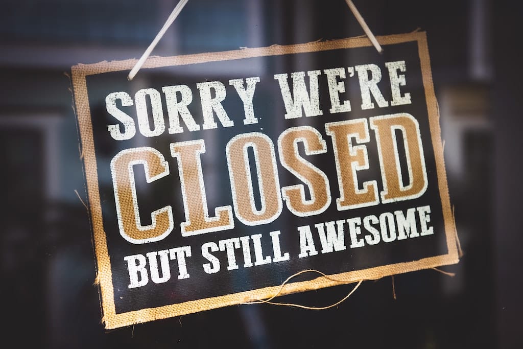 Photo of a 'closed but still awesome' sign on a storefront as a metaphor for retiring crowdfilings.com website