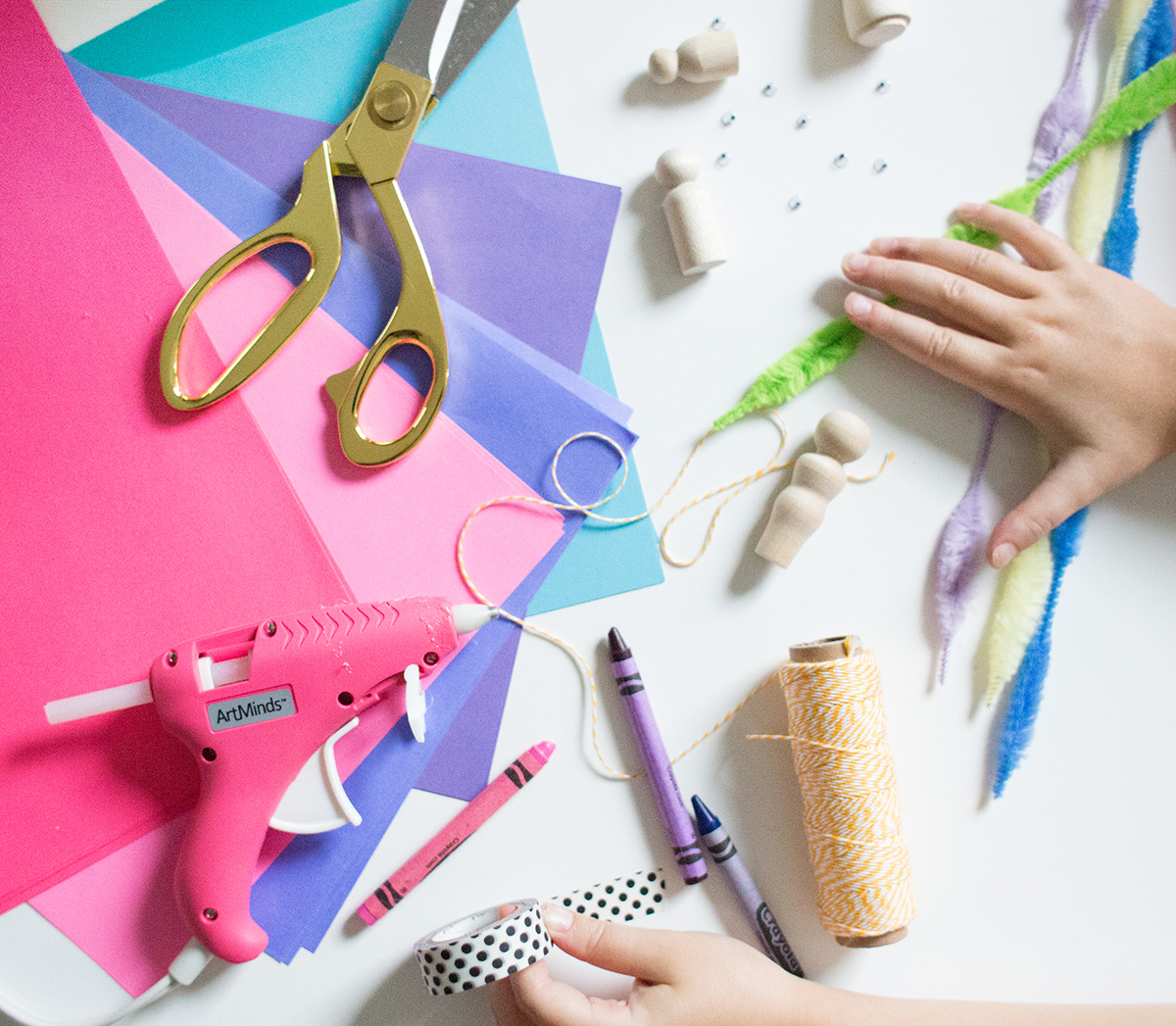 Child holds the scissors and cut out the felt flower. Scissors, hot glue  gun, sheets of felt, decorative pendant with felt butterflies and flowers  Stock Photo by ©OnlyZoia 115559608