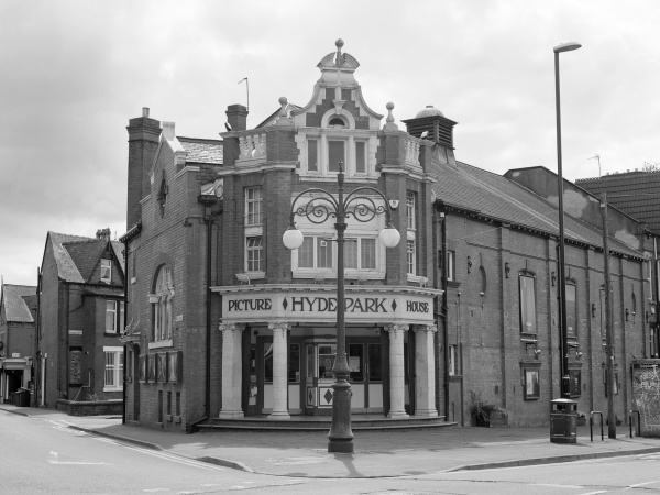 Exterior shot of Hyde Park Picture House with terraced houses visible in distance.