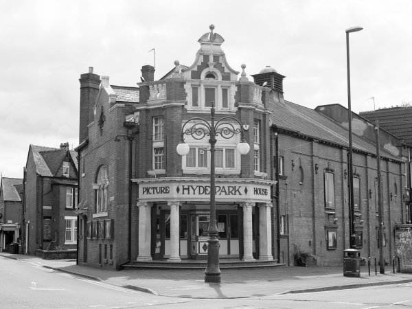 Exterior shot of Hyde Park Picture House with terraced houses visible in distance.