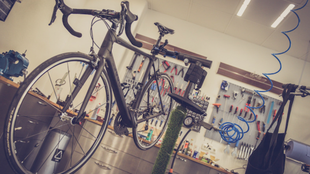 Photo of a bicycle in a repair shop by Alexander Dummer via Canva