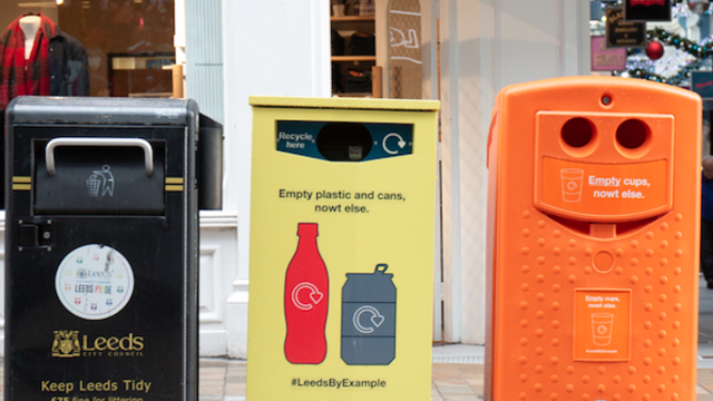 Image of three bins - a belly bin, a yellow recycling bin and an orange recycling bin