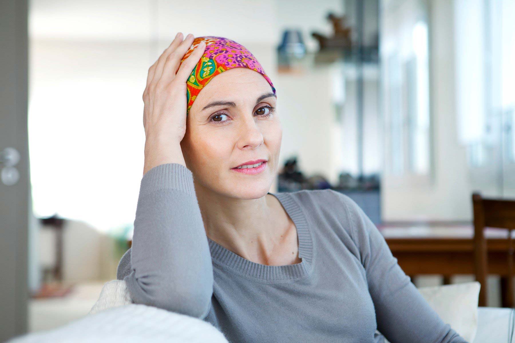 Cancer Center - woman holding her hand on head with scarf