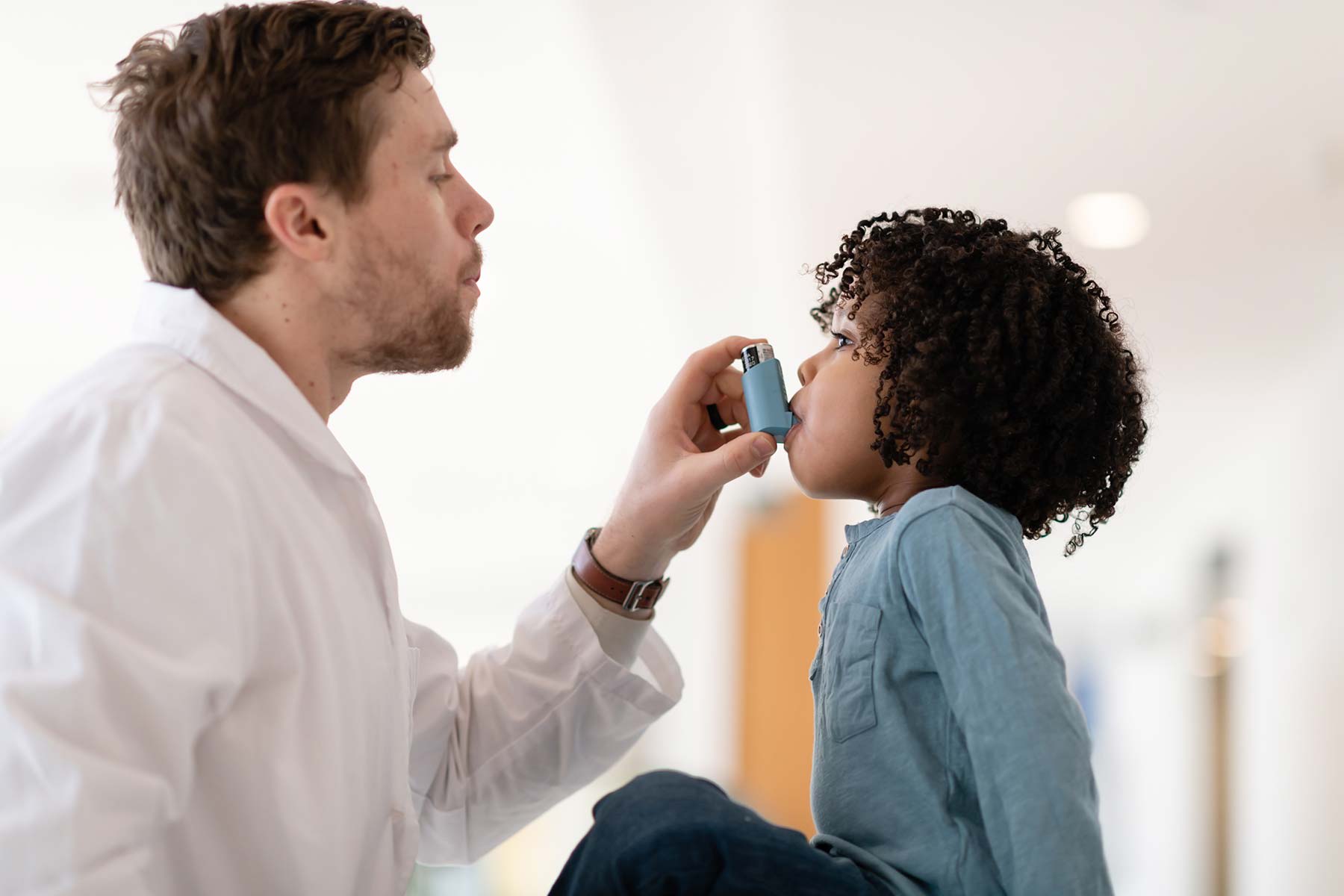 Respiratory Therapy - provider helping child with inhaler