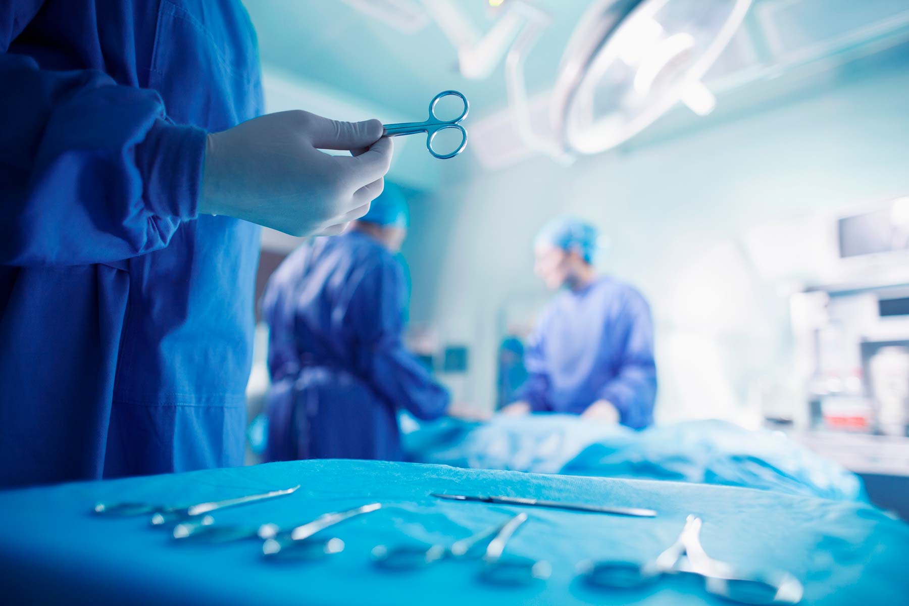 Surgical Services - provider holding tool in operating room