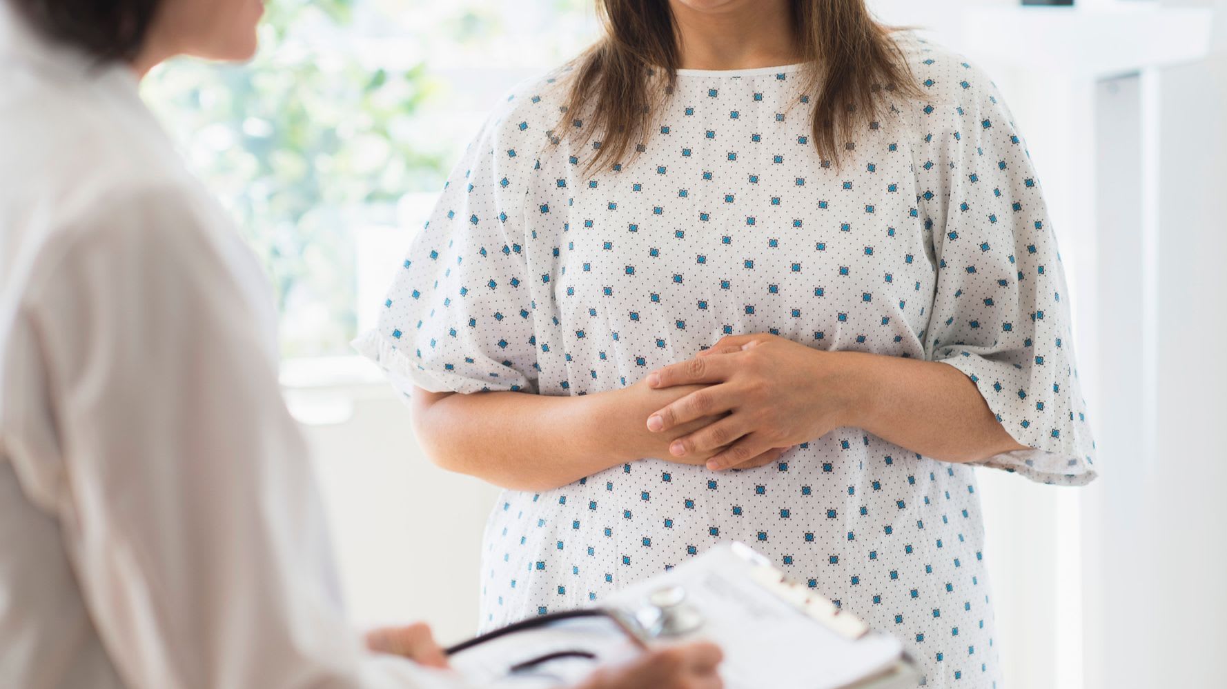 Weight Management & Bariatric Surgery - provider and patient with arms across abdomen
