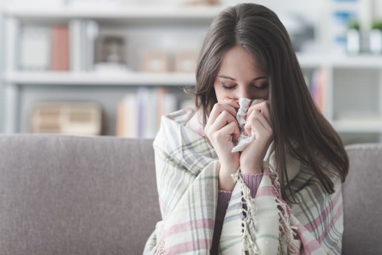 woman blowing her nose - flu