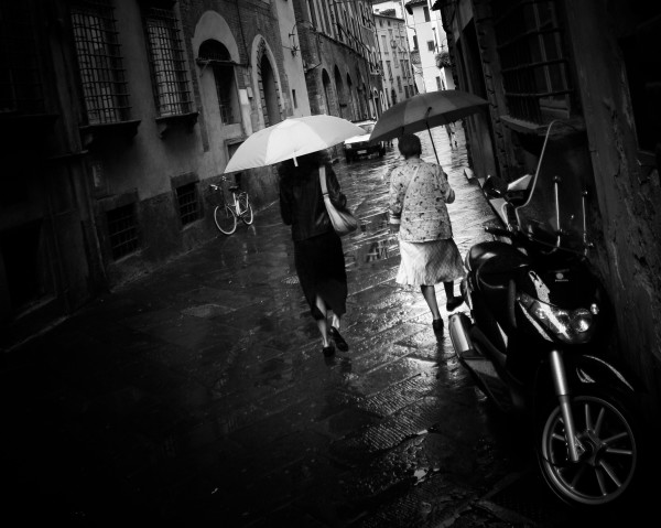 Two umbrellas and a bicycle