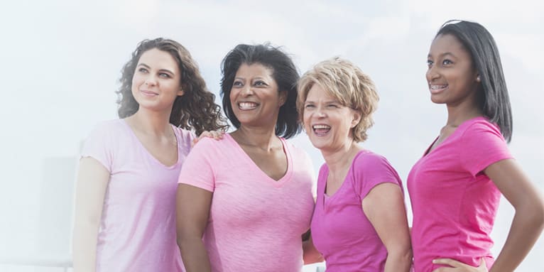 Four women stand strong together.